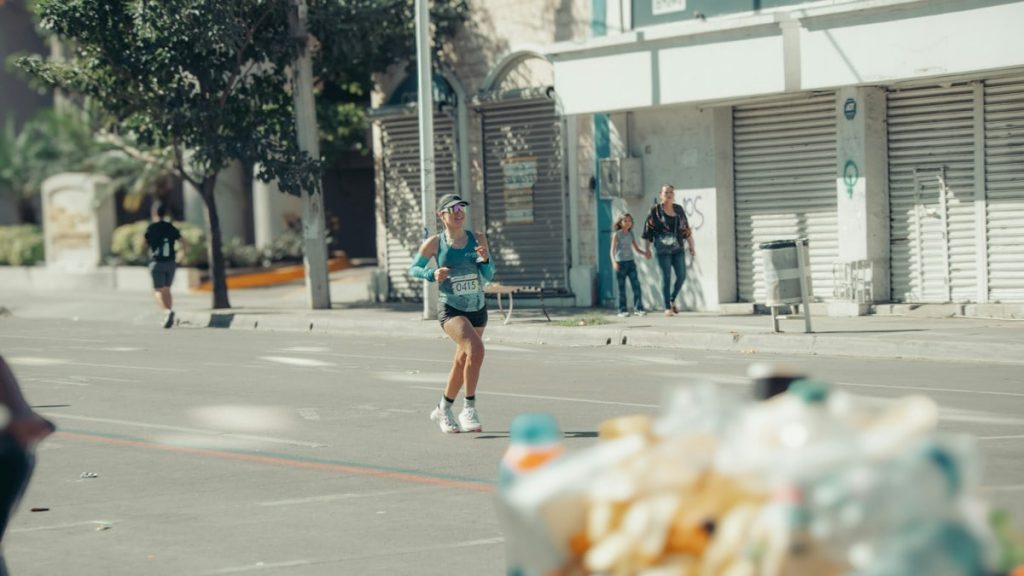 Woman running in a marathon race on a sunny day